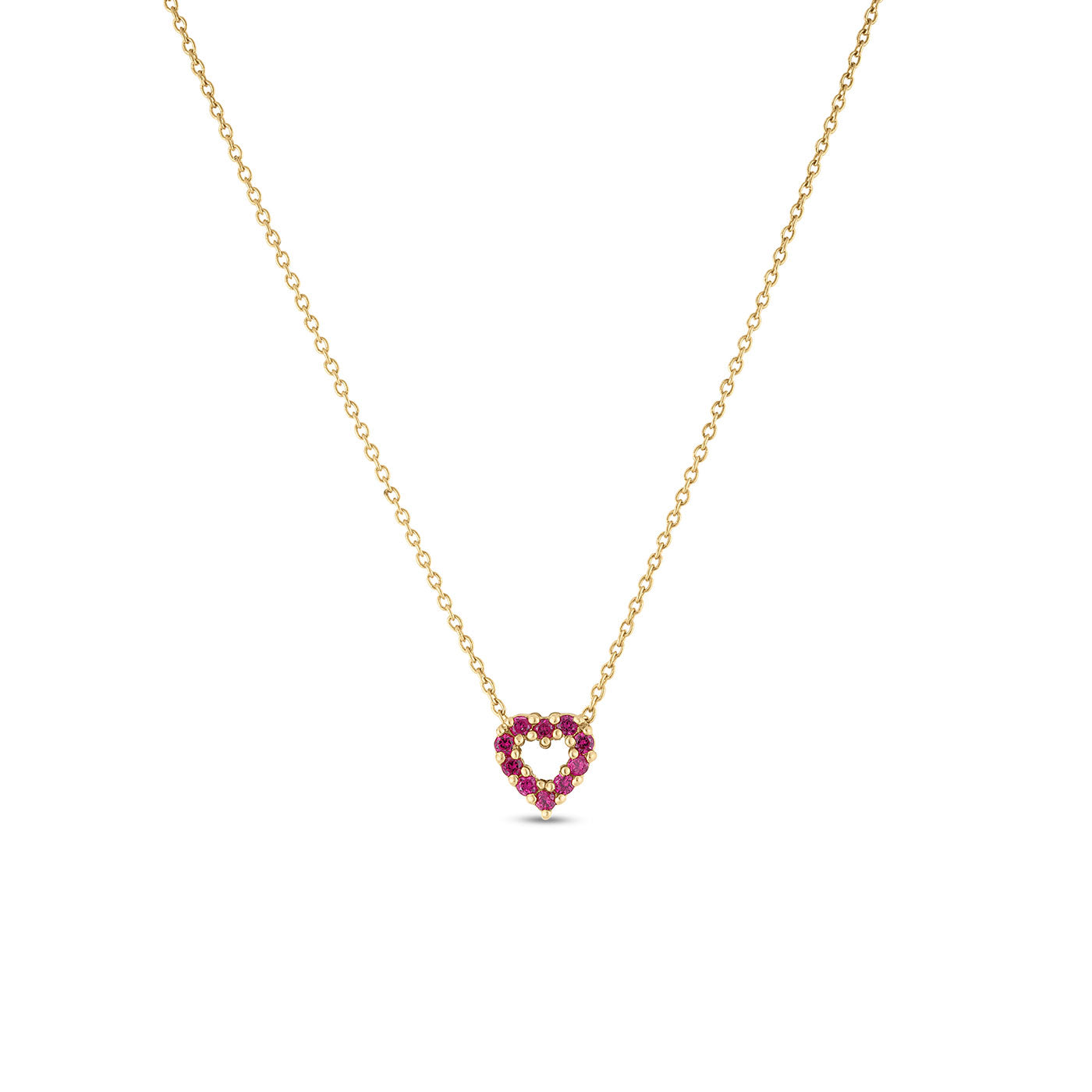 The Roberto Coin Tiny Treasures 18K Yellow Gold Diamond Necklace Pendant showcases a delicate chain and a heart-shaped charm adorned with small red gemstones. A round diamond subtly enhances the pendant’s allure as it hangs gracefully from the fine chain, embodying the exquisite craftsmanship of Roberto Coin.