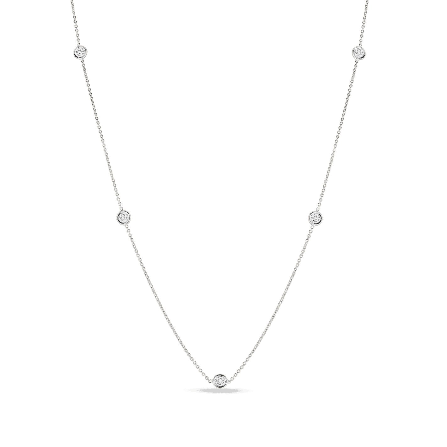 The Roberto Coin Diamonds By The Inch 18K White Gold Five Station Necklace epitomizes exquisite craftsmanship, featuring a delicate arrangement of small round diamond pendants evenly spaced along the chain.