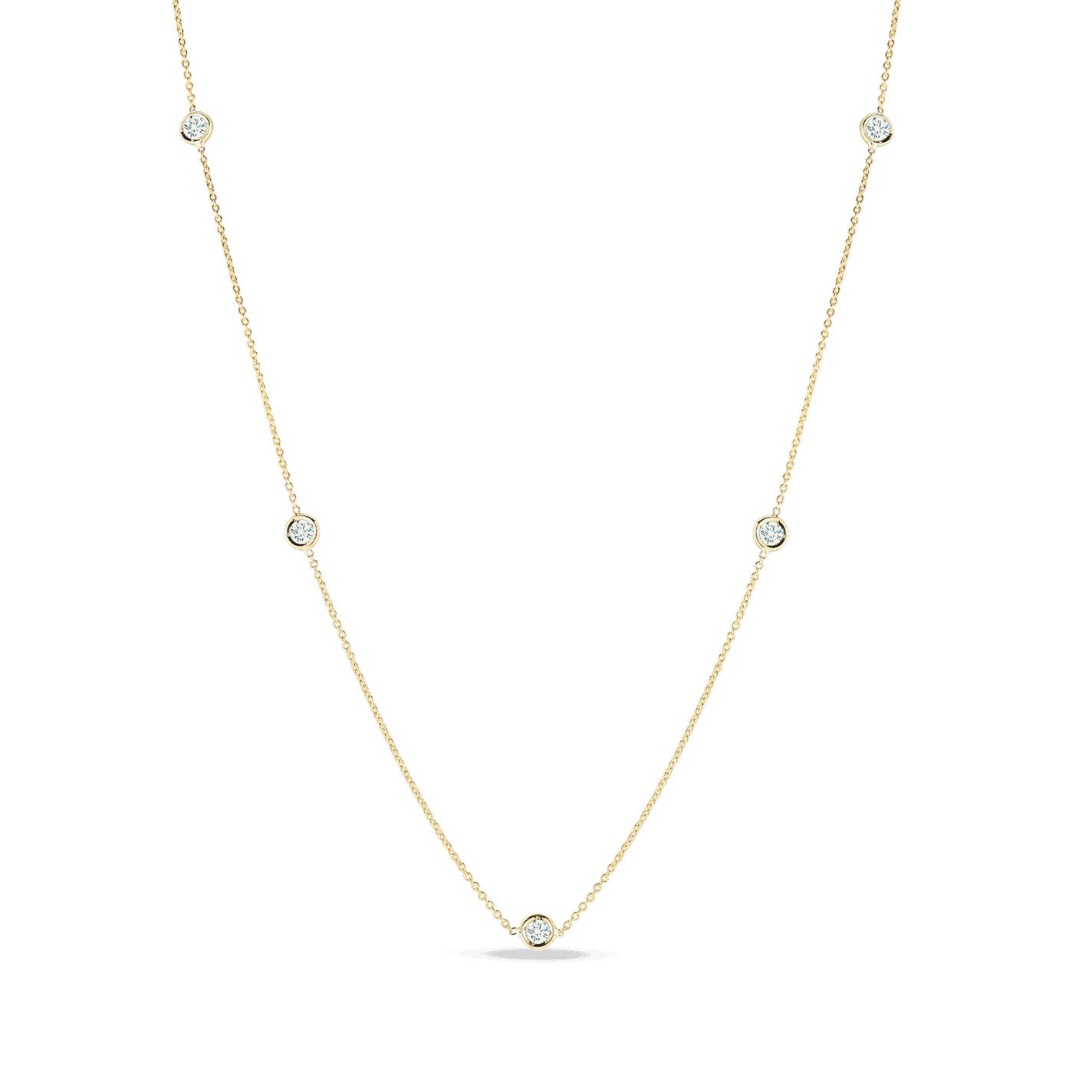 The Roberto Coin Diamonds By The Inch 18K Yellow Gold Five Station Necklace is a delicate piece featuring evenly spaced small diamond accents set in circular bezels. This simple, elegant design by Roberto Coin highlights the sparkle of five diamonds and forms a slight curve, indicating a natural drape.
