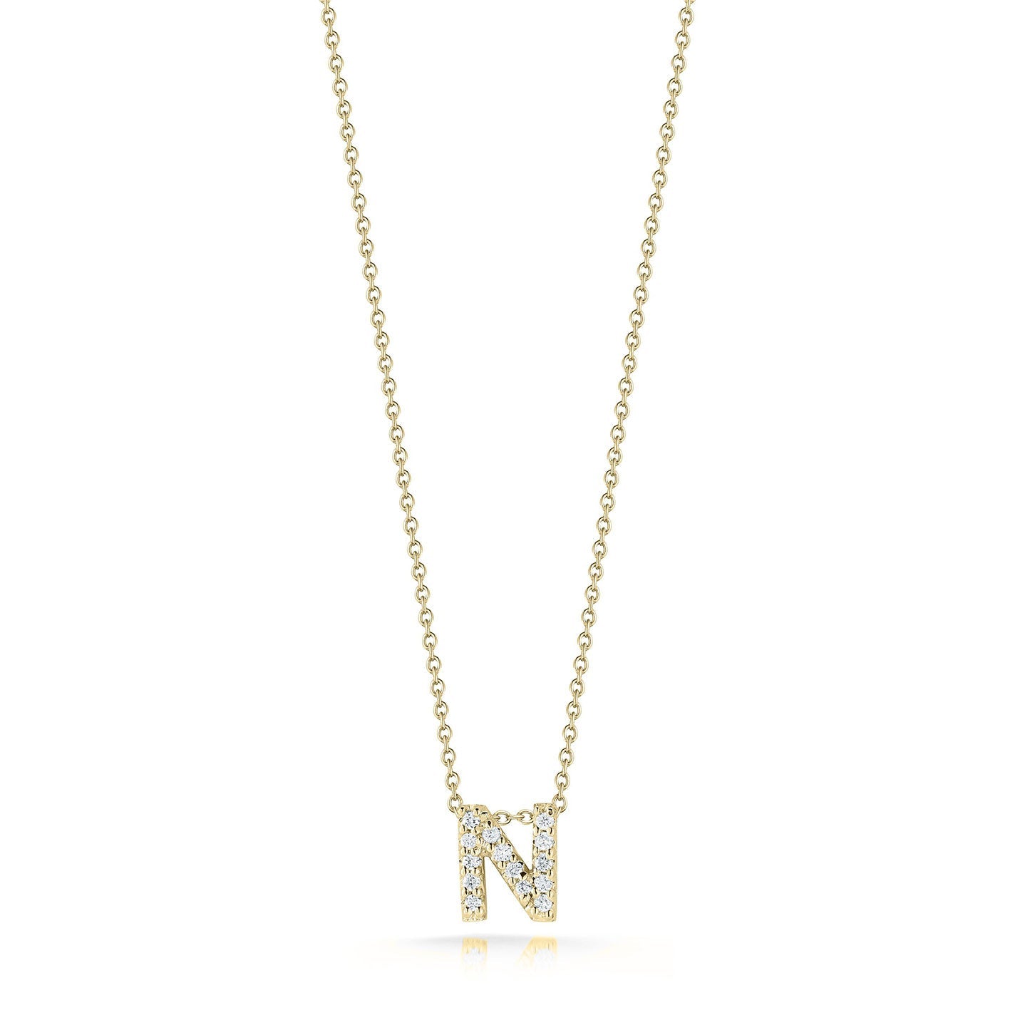 The Roberto Coin Tiny Treasures Love Letter 18K Yellow Gold Diamond Initial Necklace Pendant features a gold necklace with an "N"-shaped pendant, embellished with approximately 0.07 tcw of dazzling diamonds, suspended from an 18″ delicate chain. The plain white background gracefully showcases the jewelry by Roberto Coin.