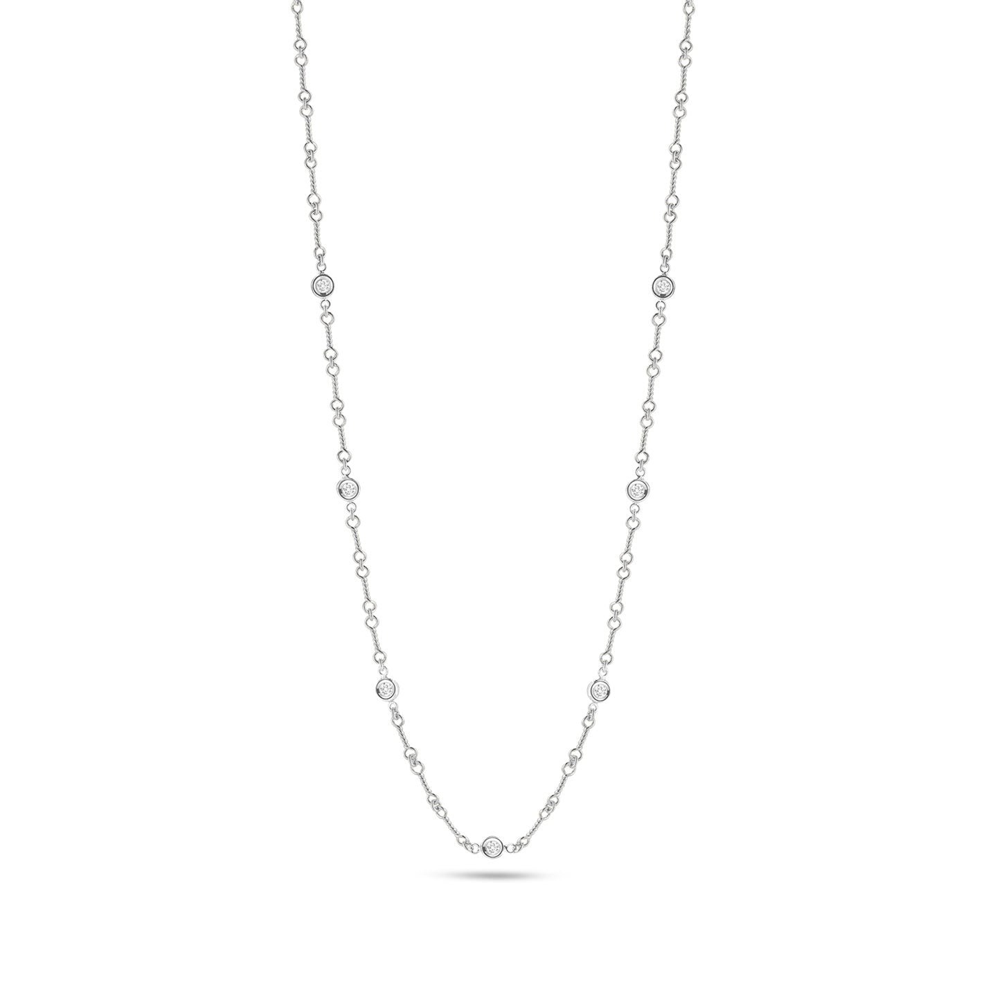 Explore the sophistication of the Roberto Coin Diamonds By The Inch 18K White Gold Seven Station Necklace. This exquisite necklace features evenly spaced round diamonds along a luxurious 18 karat white gold chain, beautifully accentuated against a pure white backdrop.