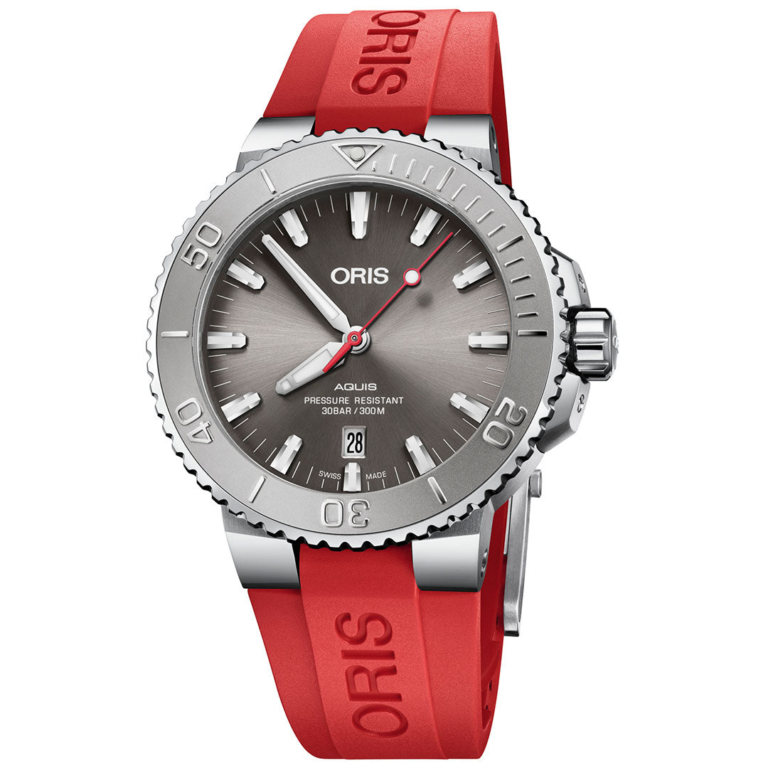 This Swiss Made wristwatch, the Oris Aquis Date Relief Automatic Winding 43.5mm Watch by ORIS, boasts a silver stainless steel case and gray dial. It features a red rubber strap, luminous hour markers, and a date display. With its engraved numeral bezel and impressive water-resistance rating, it's both stylish and functional.