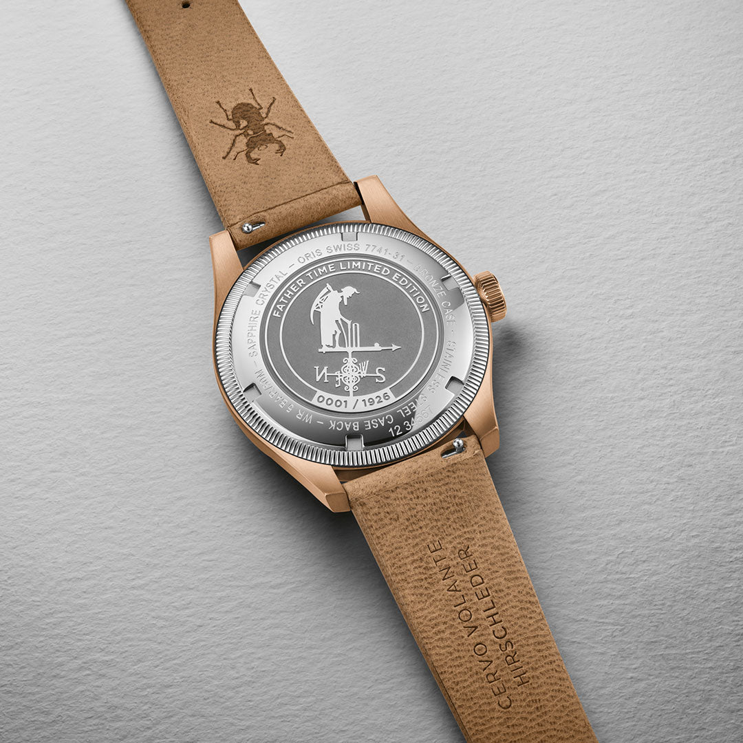 The image showcases the back of an ORIS Big Crown Father Time Limited Edition Automatic Winding 40mm Watch, adorned with an engraved golf-themed illustration. The leather strap features an embossed insect motif, and text detailing around the case back emphasizes its unique craftsmanship.