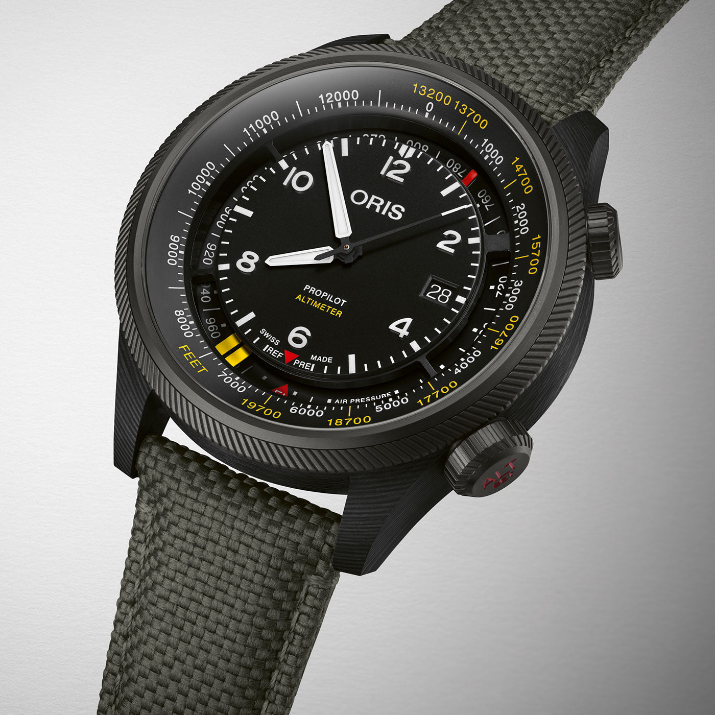A black Oris Propilot Altimeter Automatic 47mm Watch by ORIS, equipped with a fabric strap, is showcased against a neutral background. The watch face includes a date display and clear numerals, surrounded by altitude measurement indicators on the bezel.