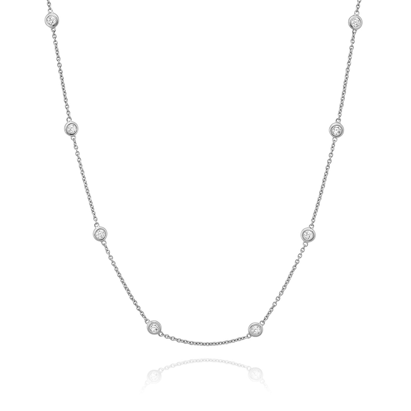 The Miss Mimi by Yael Sterling Silver Cubic Zirconia Station Necklace showcases a delicate design of small round cubic zirconia accents connected by a fine chain, all displayed on a white background.