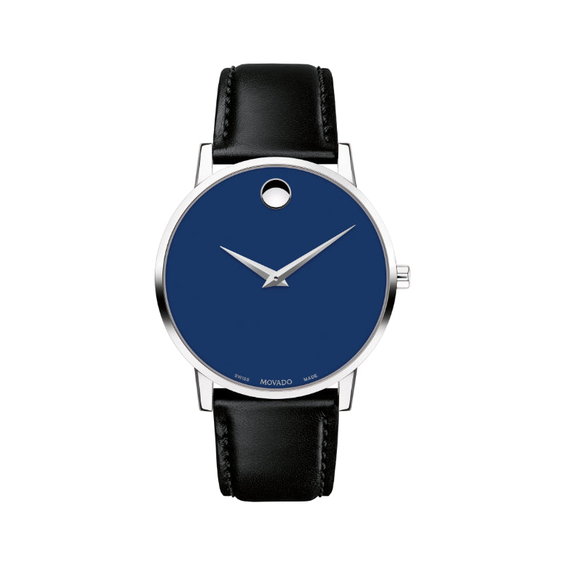 The Movado Museum Classic Quartz 33mm Watch by Movado features a minimalist design with a striking deep blue museum dial and silver hands. It is housed in a stainless steel case with a silver round shape and complemented by a black leather strap, distinctively marked at the 12 o'clock position.