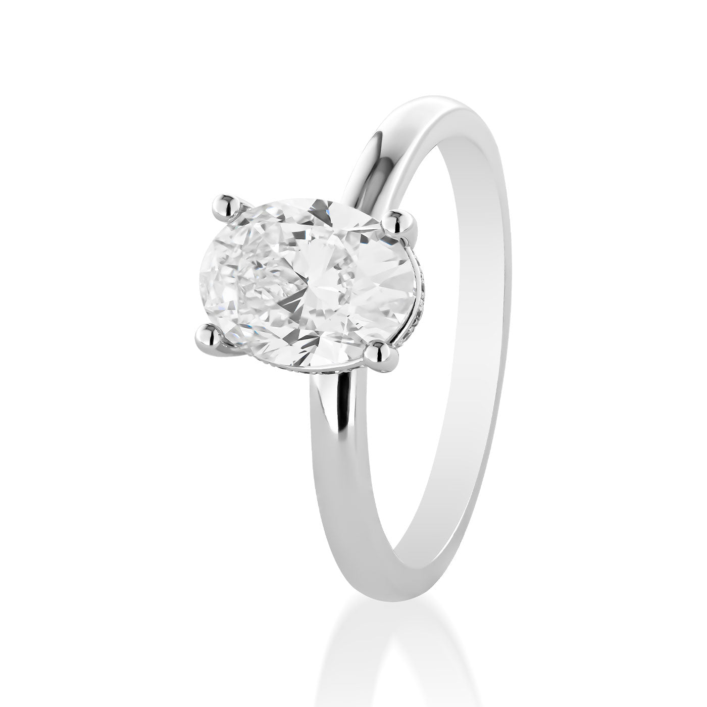 The Raffi&Co.® 18K White Gold Oval Hidden Halo Diamond Engagement Ring showcases a prominent oval-shaped diamond in a four-prong setting. Set against a white background, its simplicity and elegance are emphasized, enhanced by the hidden halo design for added sophistication.