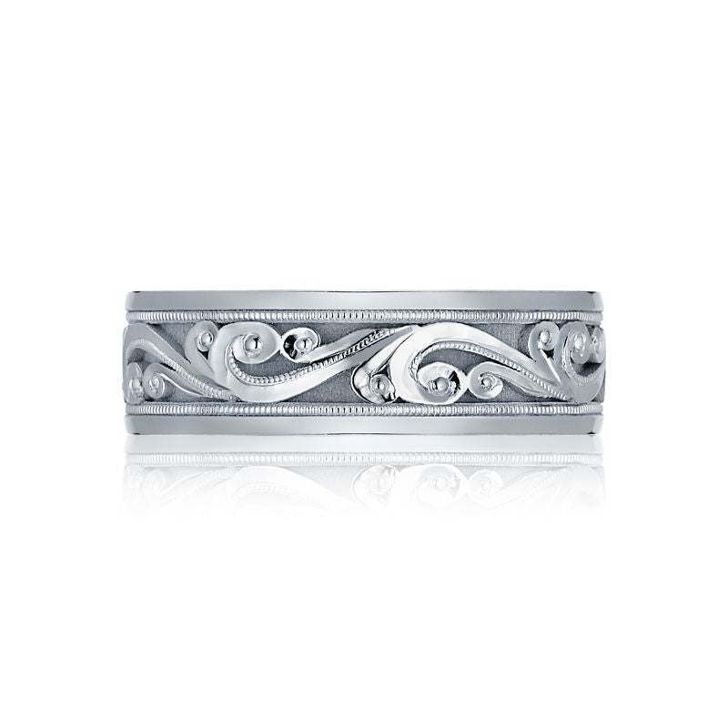 The Tacori Geometric High Polish Finish 18K White Gold Men's Wedding Band showcases intricate swirling patterns and elegant curves around the band. Its design is enhanced by fine detailing and crescent-shaped accents, resulting in a sophisticated and ornate appearance.