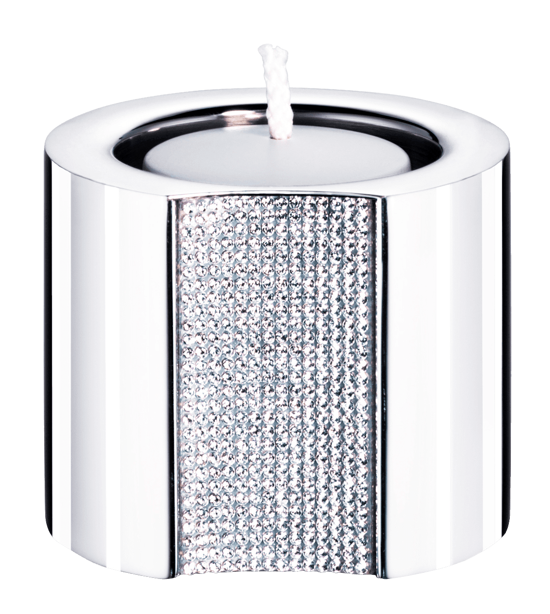 A small, round tealight candle holder from Swarovski, featuring a shiny silver metallic finish and a textured Swarovski Crystal accent on one side. A white tealight candle sits inside, adding an elegant touch inspired by Swarovski’s signature refined style.