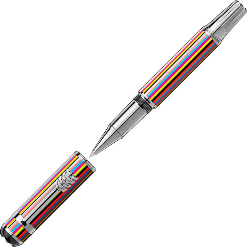 The Montblanc Great Characters The Beatles Special Edition Rollerball Pen features a metallic design with colorful stripes reminiscent of "Sgt. Pepper's Lonely Hearts Club Band" in yellow, red, green, and blue hues. Its cap is placed to the side to showcase the pen’s nib.