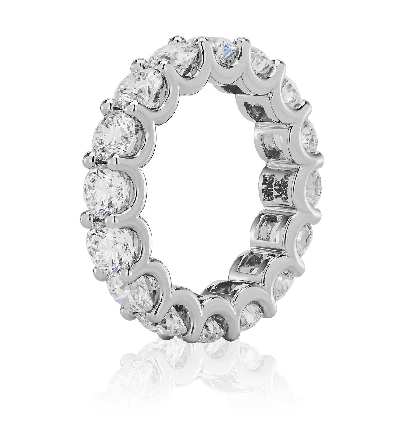 The Raffi&Co.® Signature 18K White Gold Round Brilliant Diamond Eternity Ring features round brilliant diamonds in a scalloped prong setting, crafted in white gold, and is displayed on a white background with a reflection.