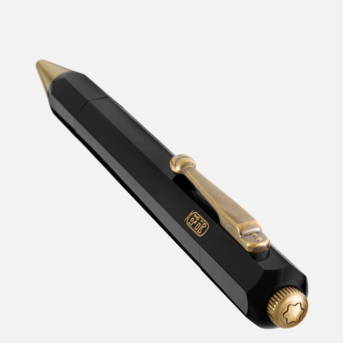 The Montblanc Heritage Egyptomanian Special Edition Black Ballpoint Pen, by Montblanc, boasts a luxurious design with gold accents. It features an octagonal barrel, a gold clip with an ornate design, and a gold tip. Angled diagonally to showcase its elegance and refinement, the pen draws inspiration from the Montblanc Heritage Egyptomania collection.