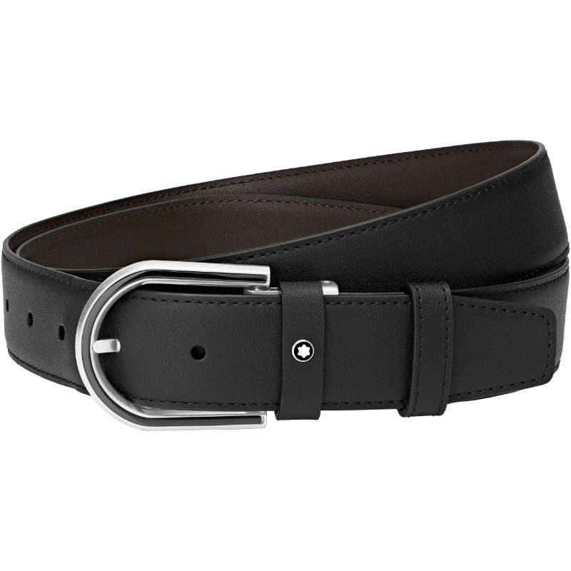 The Montblanc Leather Belt by Montblanc is crafted from black matte leather, showcasing a sleek, polished appearance with a silver buckle. The end is threaded through the buckle and features a small hole near the stud, enhancing its stylish design.