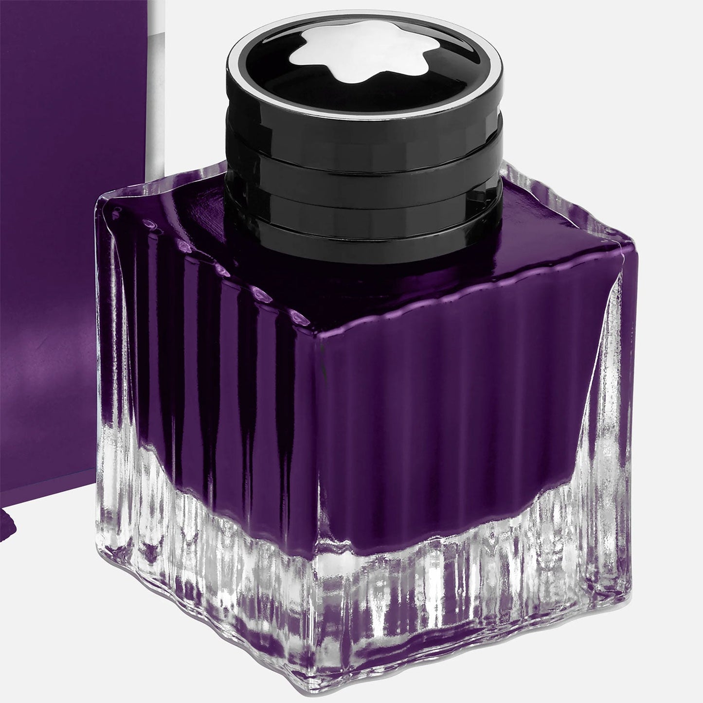 This Montblanc Ink Bottle, a 50ml Great Characters Enzo Ferrari special edition, contains rich purple ink. The black cap is adorned with a white star-shaped emblem, highlighting its elegant design. Ribbed sides enhance its unique appeal.