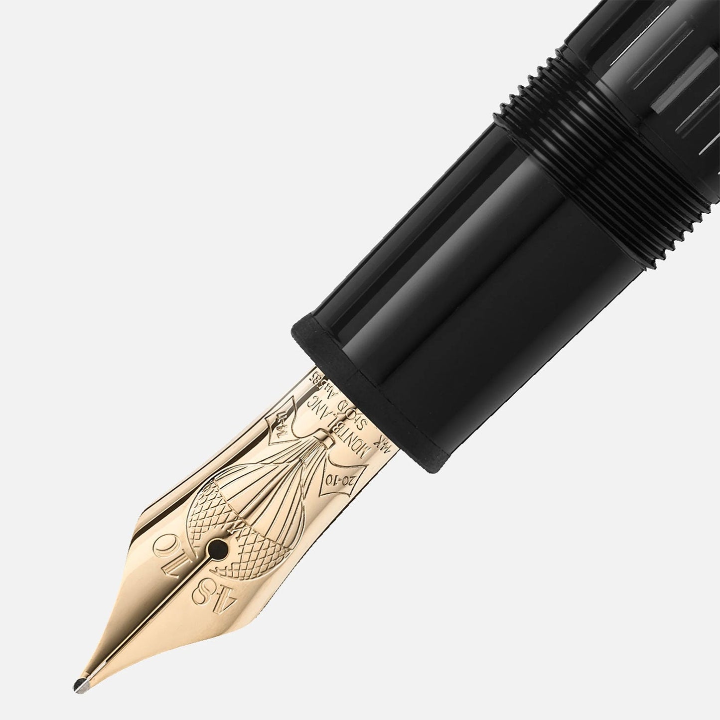 Close-up of a Montblanc Meisterstück Around the World in 80 Days Legrand fountain pen nib with intricate engraving, showcasing a luxurious gold and black design. The nib is slightly angled, its craftsmanship echoing the elegance of "Around the World in 80 Days," set against a plain background.