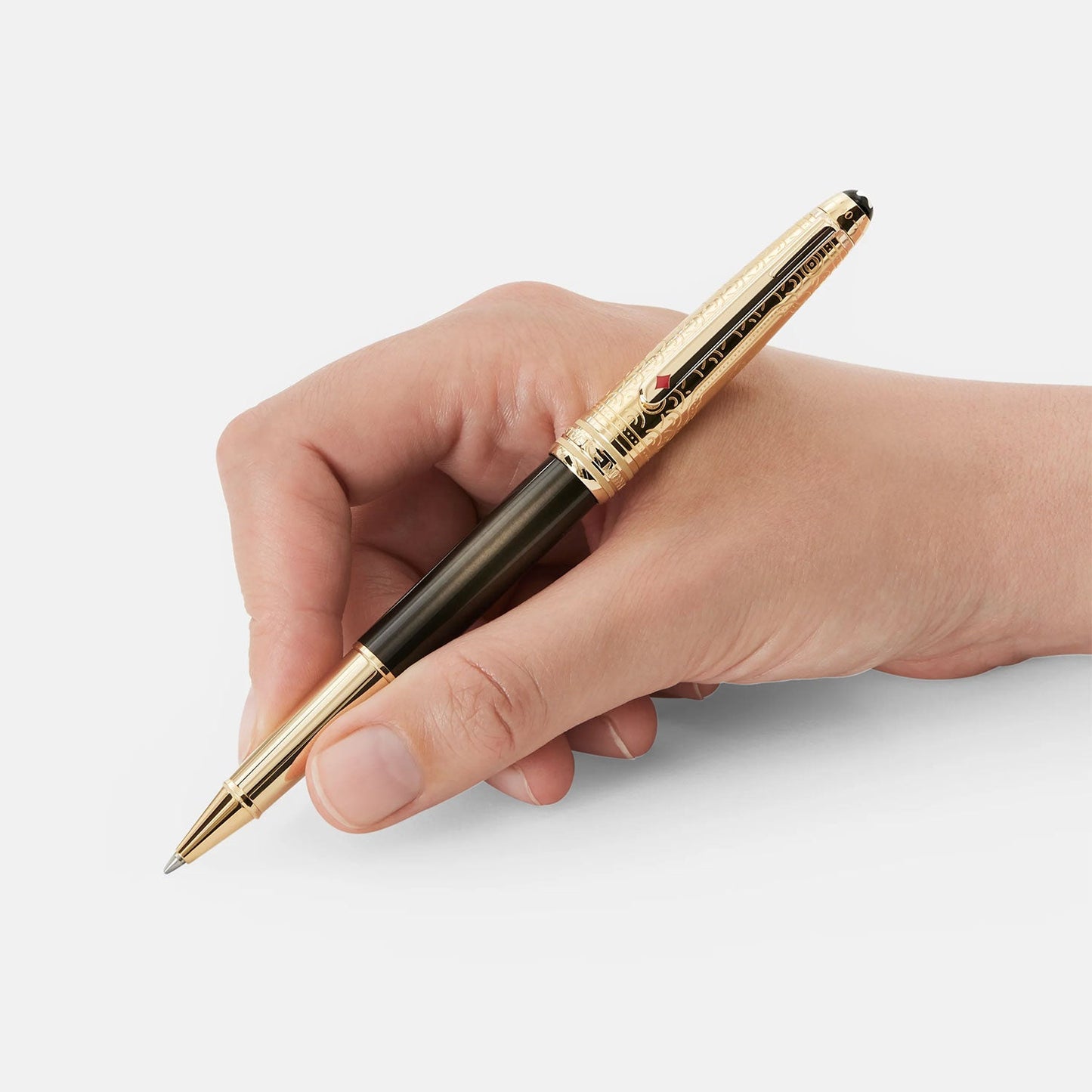A hand holding a Montblanc Meisterstück Around the World in 80 Days Doué Classique Rollerball Pen, featuring a black body and gold accents, against a plain white background.