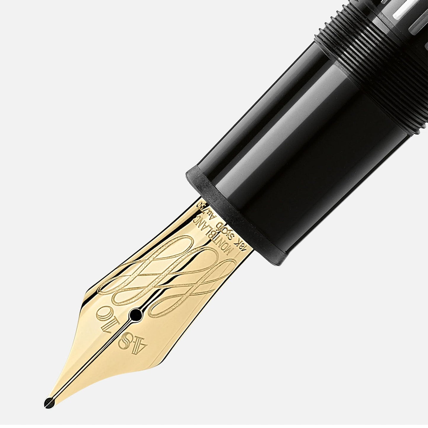 A close-up of the Montblanc Pen Meisterstück Le Grand Calligraphy Flexible Nib Fountain Pen, featuring an intricately engraved nib with a luxurious gold finish and elegant black casing. The detailed and flexible nib stands out against a light gray background, perfectly capturing the essence of luxury writing by Montblanc.