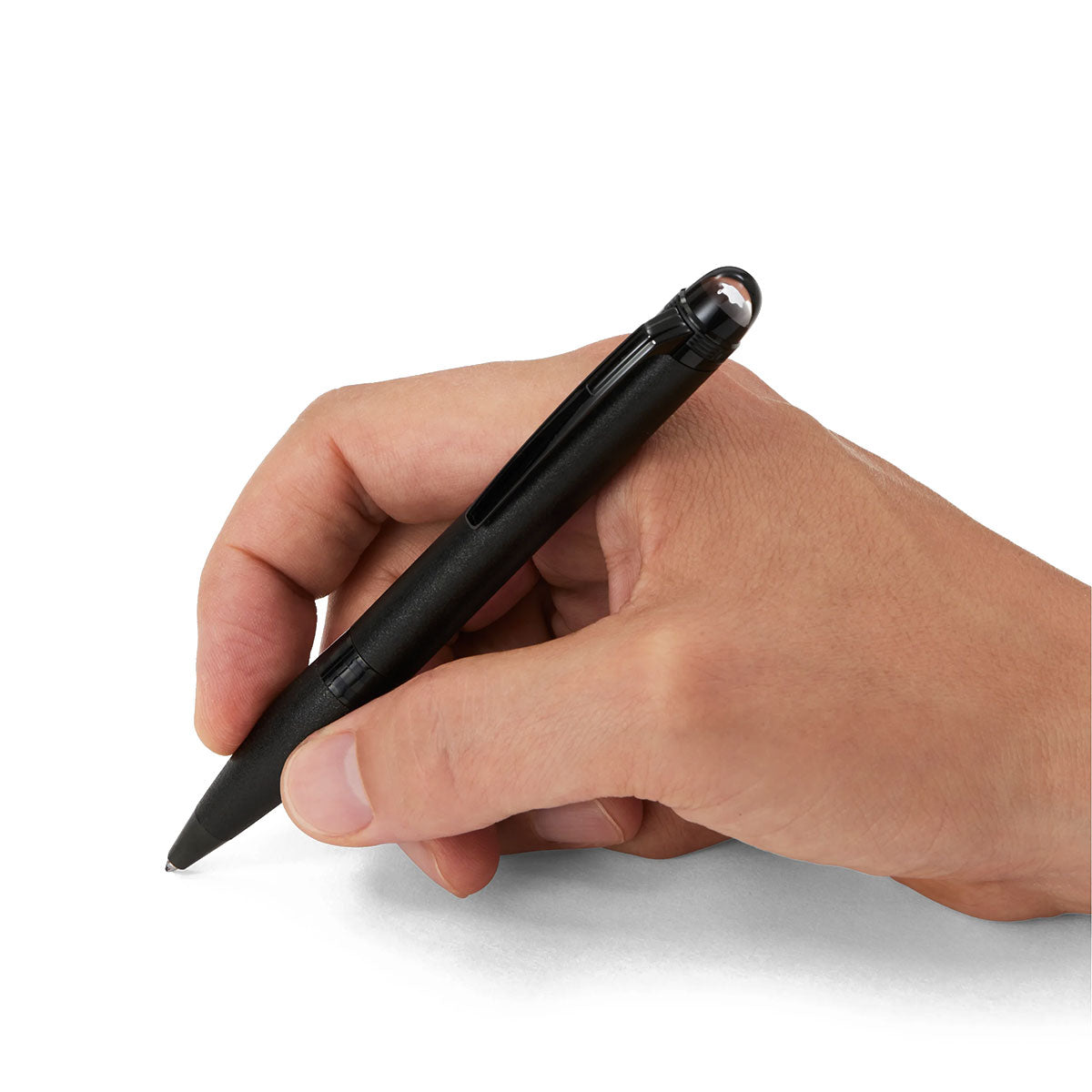 A hand holding a sophisticated Montblanc StarWalker Black Cosmos Metal Ballpoint Pen is poised to write on a blank surface, encapsulating the spirit of space exploration.