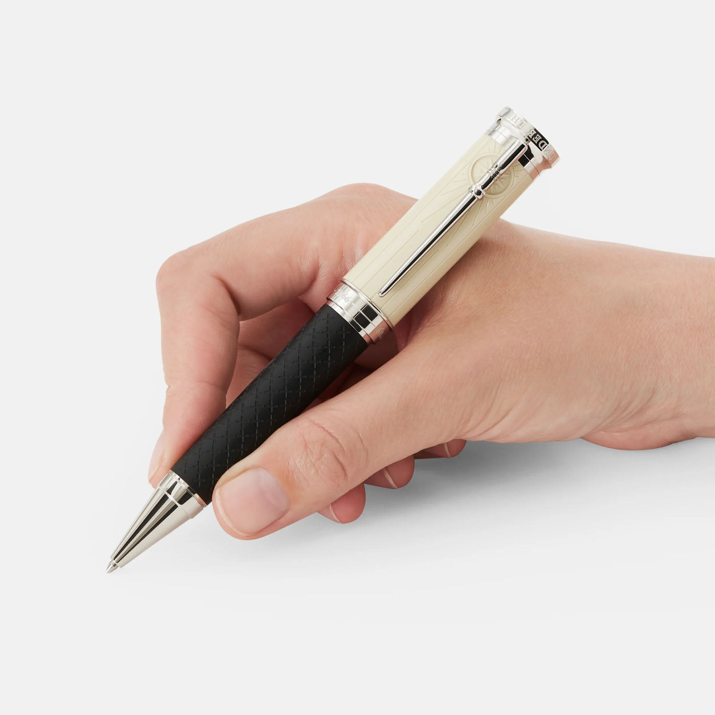 A hand holds a sophisticated Montblanc Writers Edition Homage to Robert Louis Stevenson Limited Edition Ballpoint Pen, featuring a white barrel and black grip. The pen showcases intricate detailing inspired by "Treasure Island." The background is plain white.