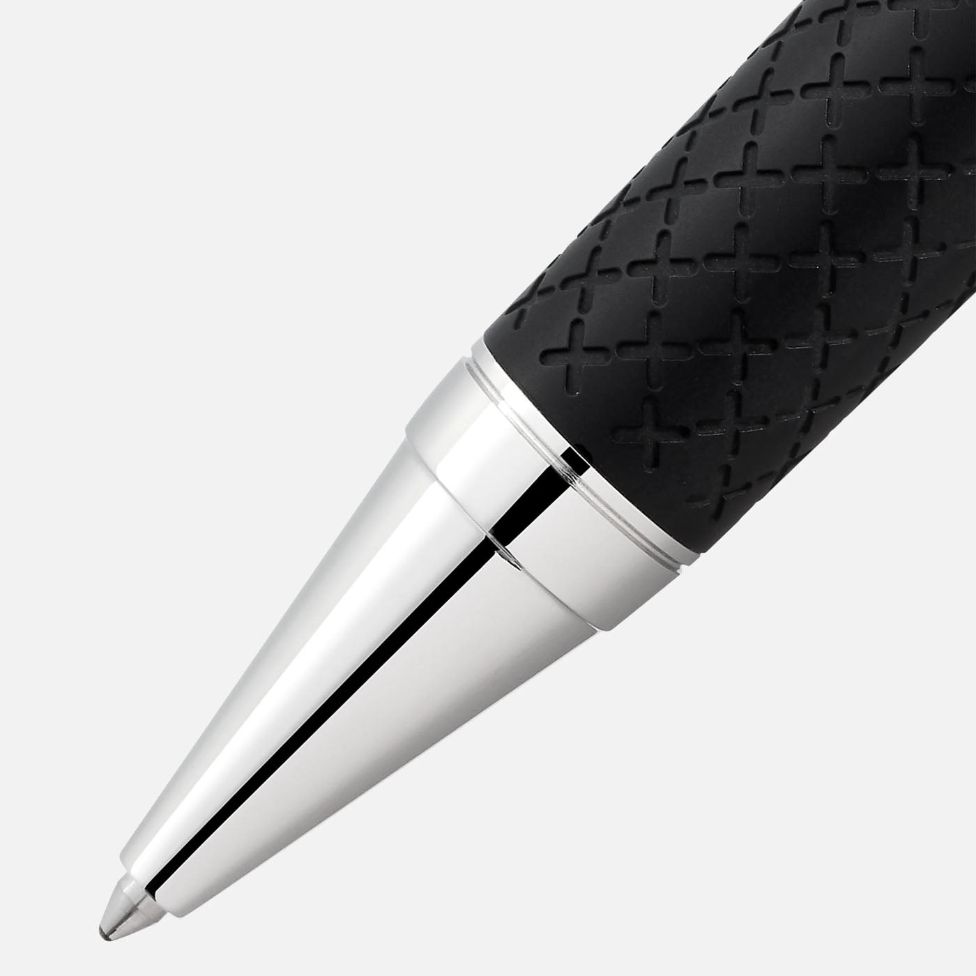 A close-up of the Montblanc Writers Edition Homage to Robert Louis Stevenson Limited Edition Ballpoint Pen highlights its black, textured grip complemented by chrome accents. The polished, pointed tip offers a sleek, modern aesthetic that echoes the adventurous essence of Stevenson's Treasure Island. The crisscross pattern enhances both style and functionality.