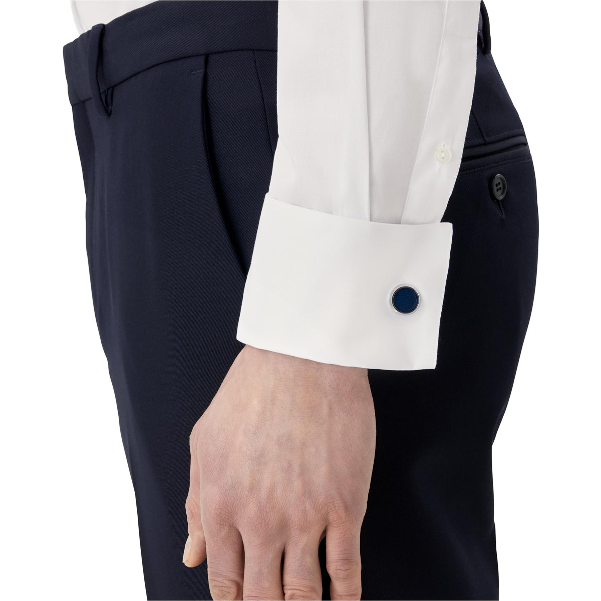 Close-up of a person wearing dark trousers and a white dress shirt featuring French cuffs, elegantly fastened with Montblanc Meisterstück Glacier Collection Cufflinks. The arm hangs relaxed by the side, with the hand partially visible.