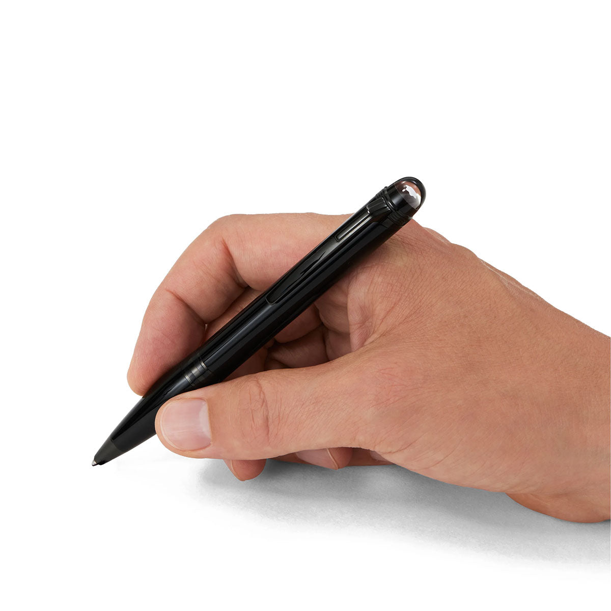 A hand holding a sophisticated Montblanc StarWalker Black Cosmos Precious Resin Fineliner Pen, poised to write on a blank white surface and set out on its own journey of space exploration.