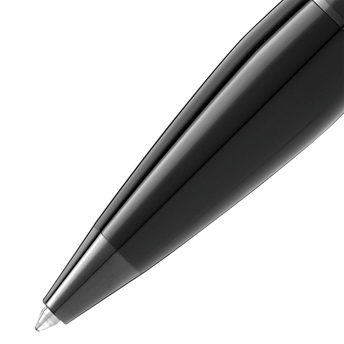 A close-up of the elegant Montblanc Starwalker Black Cosmos Precious Resin Ballpoint Pen showcases its shiny black surface and fine writing tip against a white background.