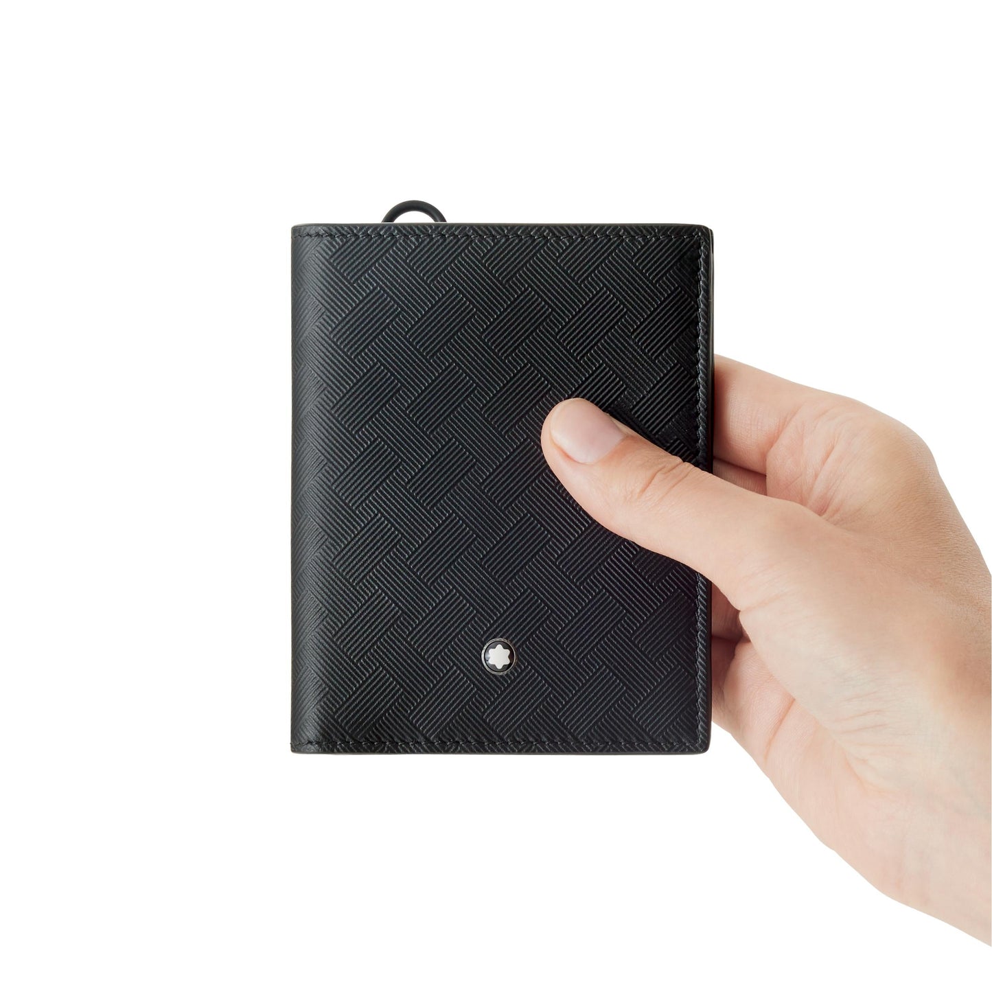 A hand holding a Montblanc Extreme 3.0 Compact Leather Wallet 6cc against a plain white background. This textured wallet, from Montblanc's Extreme 3.0 collection, showcases a small circular emblem on its front.