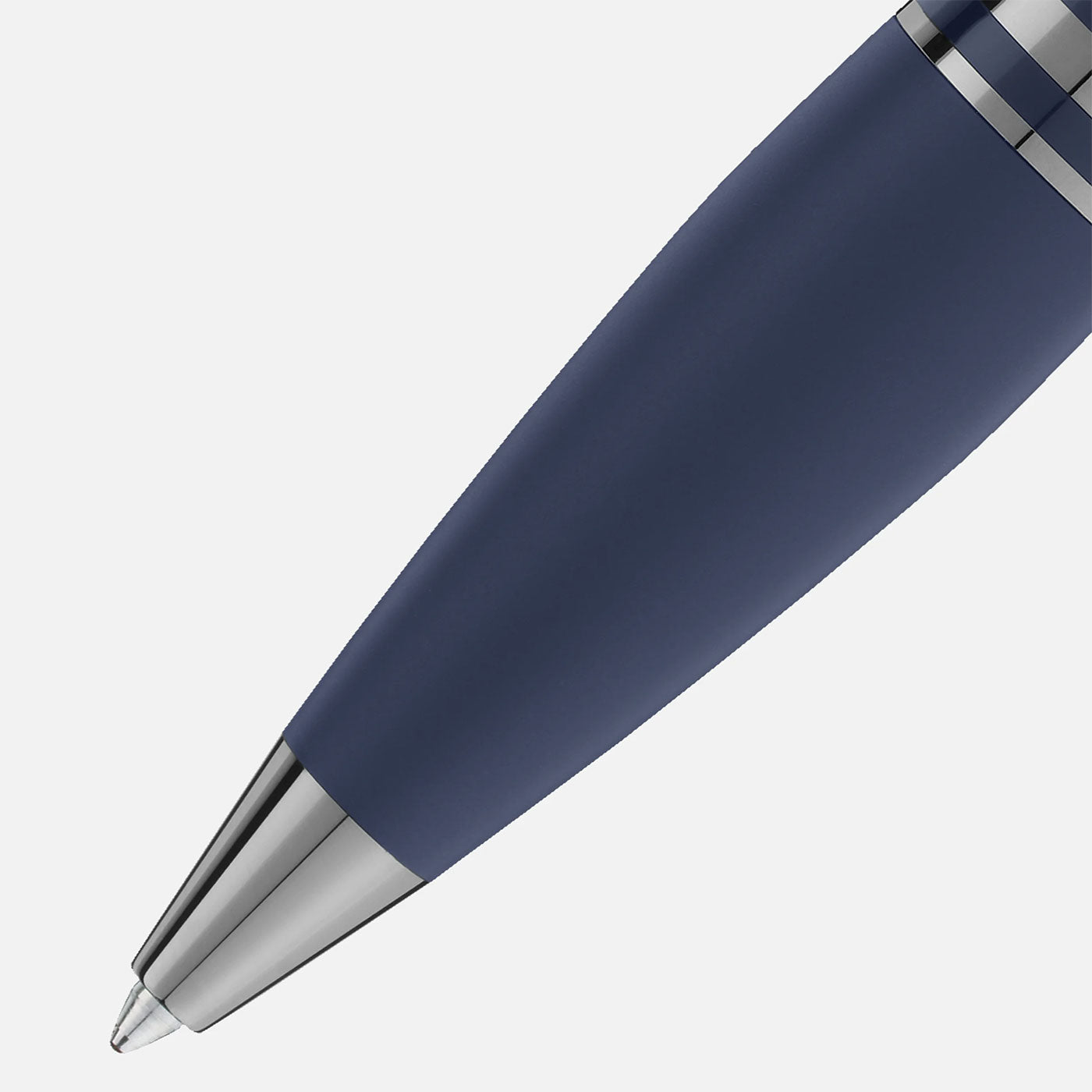 A close-up of the Montblanc Starwalker SpaceBlue Resin Ballpoint Pen, featuring a sleek design in a deep space blue and silver color scheme with a shiny metallic tip. The pen is positioned diagonally against a light gray background, highlighting its sophisticated and elegant aesthetic.