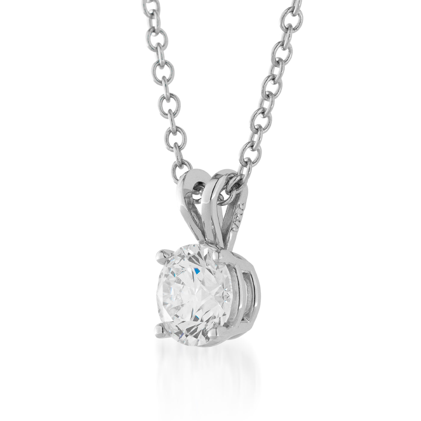 Presenting the Raffi&Co.® 18K White Gold Lab Grown Diamond Pendant Necklace, showcasing a dazzling round diamond secured in a classic four-prong setting. The pendant, accentuated by a sleek and polished bail, gracefully hangs from an elegant 18K white gold chain against a simple white backdrop.