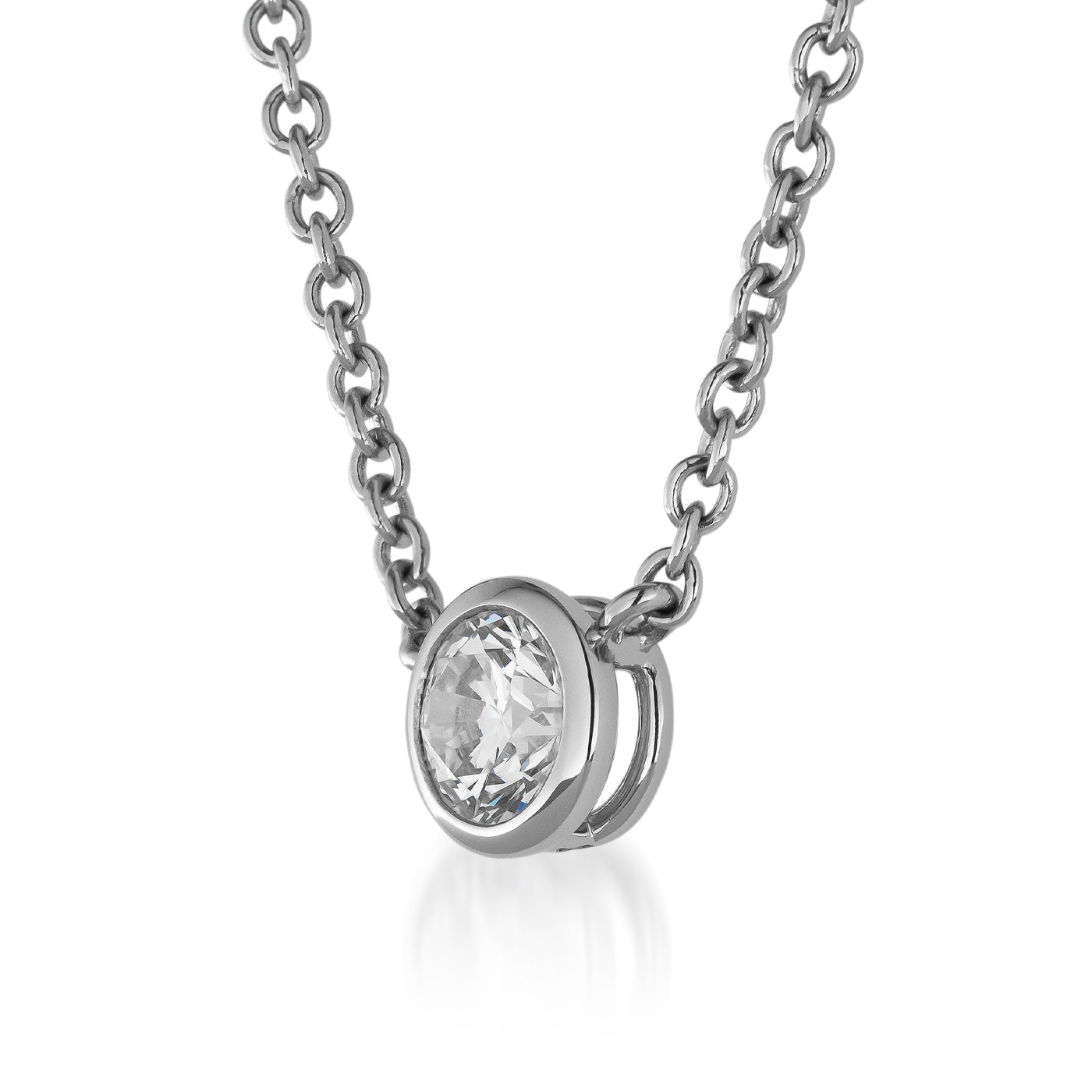 A close-up of the Raffi&Co.® Signature 14K White Gold Solitaire Diamond Pendant Necklace showcases a round solitaire diamond elegantly set in a modern bezel setting. The delicate chain beautifully complements the prominently centered pendant, which magnificently reflects light.