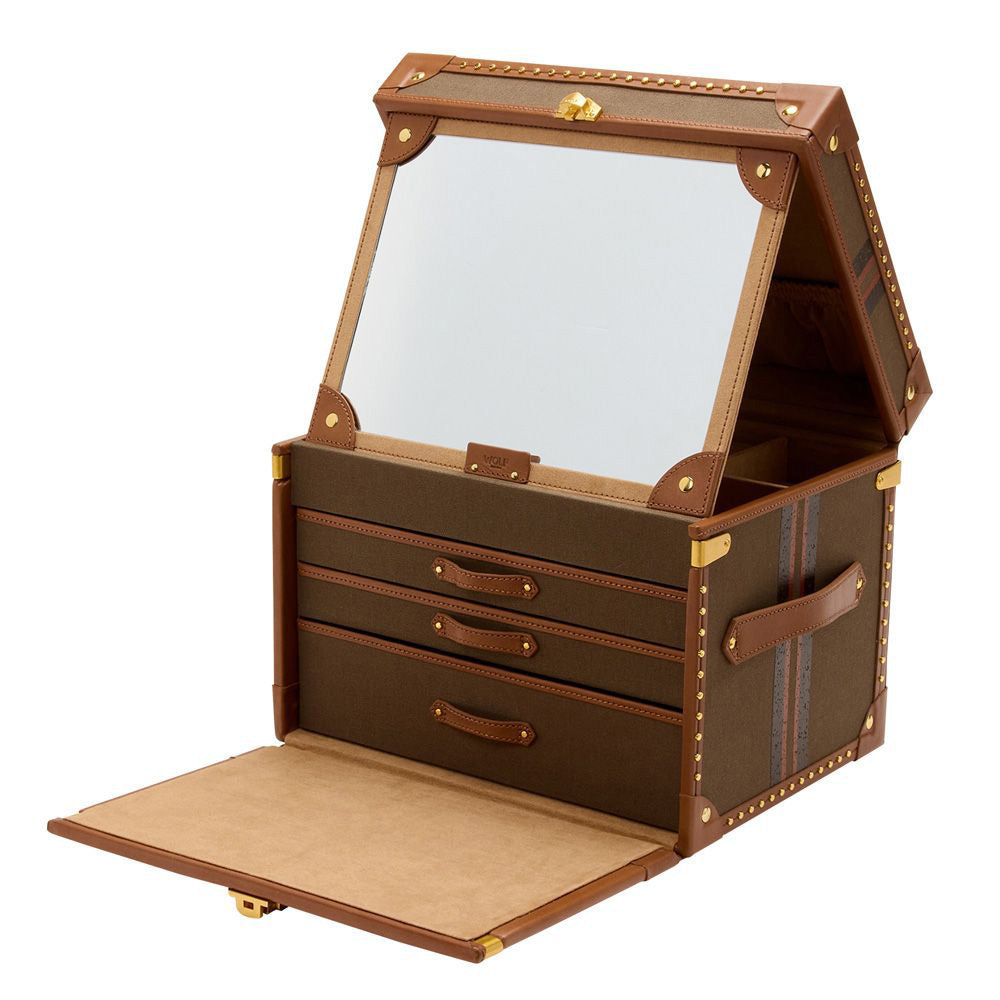 The WOLF 1834 Ida Trunk Jewellery Box showcases a vintage-style design with brass stud accents along its brown leather edges and includes a mirror inside the lid. When the lid is propped open and the front flap is down, three drawers are revealed, highlighting its elegant beige interior.