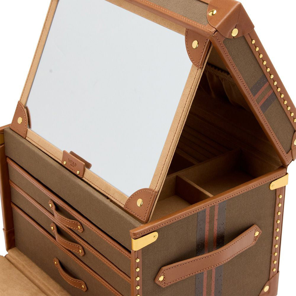 Introducing the WOLF 1834 Ida Trunk Jewellery Box by WOLF, a stylish storage solution with leather accents. This elegant brown makeup case features an open lid with a mirror, two drawers, and multiple compartments for optimal storage. It is adorned with brass stud detailing and equipped with side handles, adding a sophisticated touch to its design.