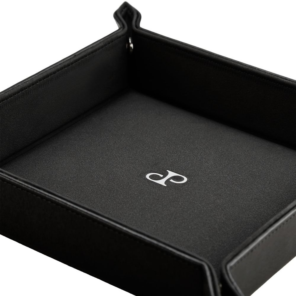 The WOLF 1834 Philipp Snap Valet Tray is a black vegan leather organizer featuring raised edges and a white stylized "DP" logo centered on the interior base.