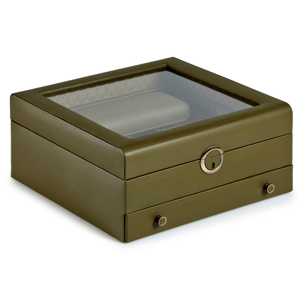 Introducing the WOLF 1834 Earth Watch Stand Box, exclusively from the WOLF brand. This elegant green box boasts a transparent lid and a secure keyhole, crafted specifically for limited edition packaging. Inside, you'll find a soft cushion designed to store your watch safely, along with two small drawers featuring round handles for extra storage options.