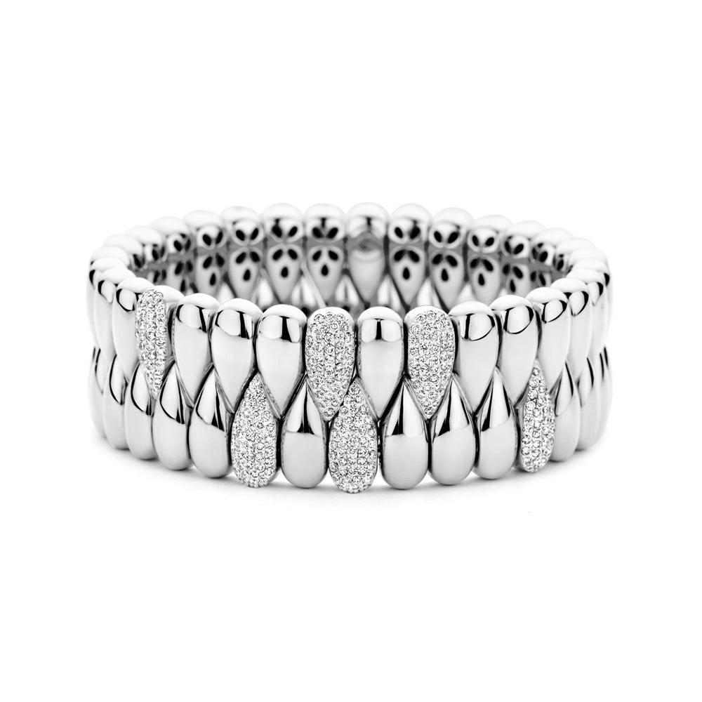 The Hulchi Belluni 18K White Gold Diamond Bracelet features rows of polished oval links, some encrusted with round brilliant diamonds totaling 1.55 CTW, displayed on a white background.