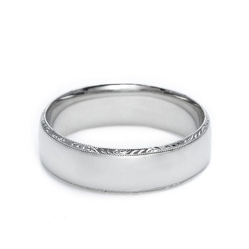 A Tacori Platinum Wedding Band featuring a smooth, polished finish and delicate details along the edges, set against a plain white background.