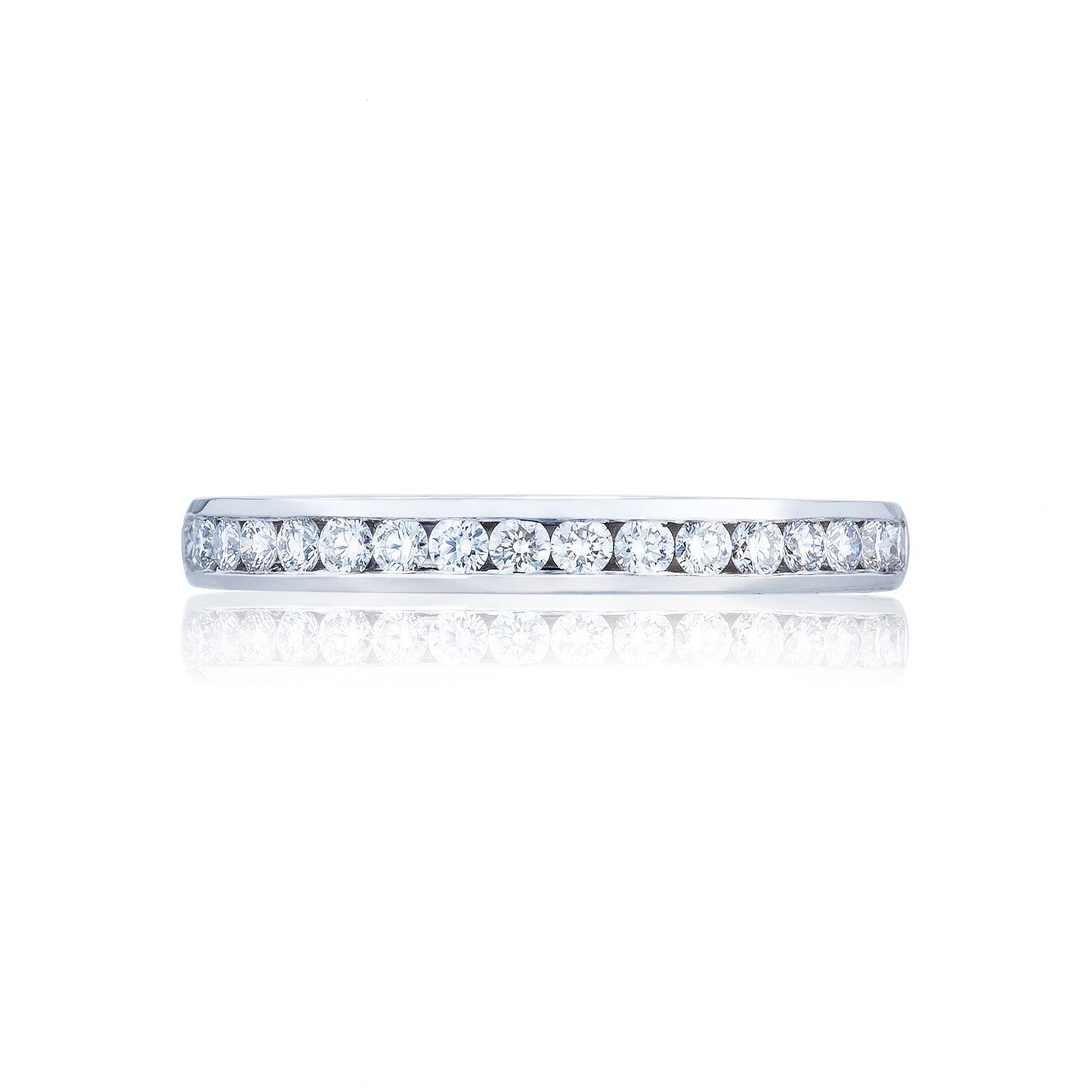 A horizontal image showcases the exquisite Tacori Dantela 18K White Gold Channel Set Round Brilliant Anniversary Ring, featuring a row of small, round diamonds that shimmer on a lustrous white gold band. Its elegance and craftsmanship are emphasized against a white background, making it an ideal choice for those in search of stunning engagement rings.