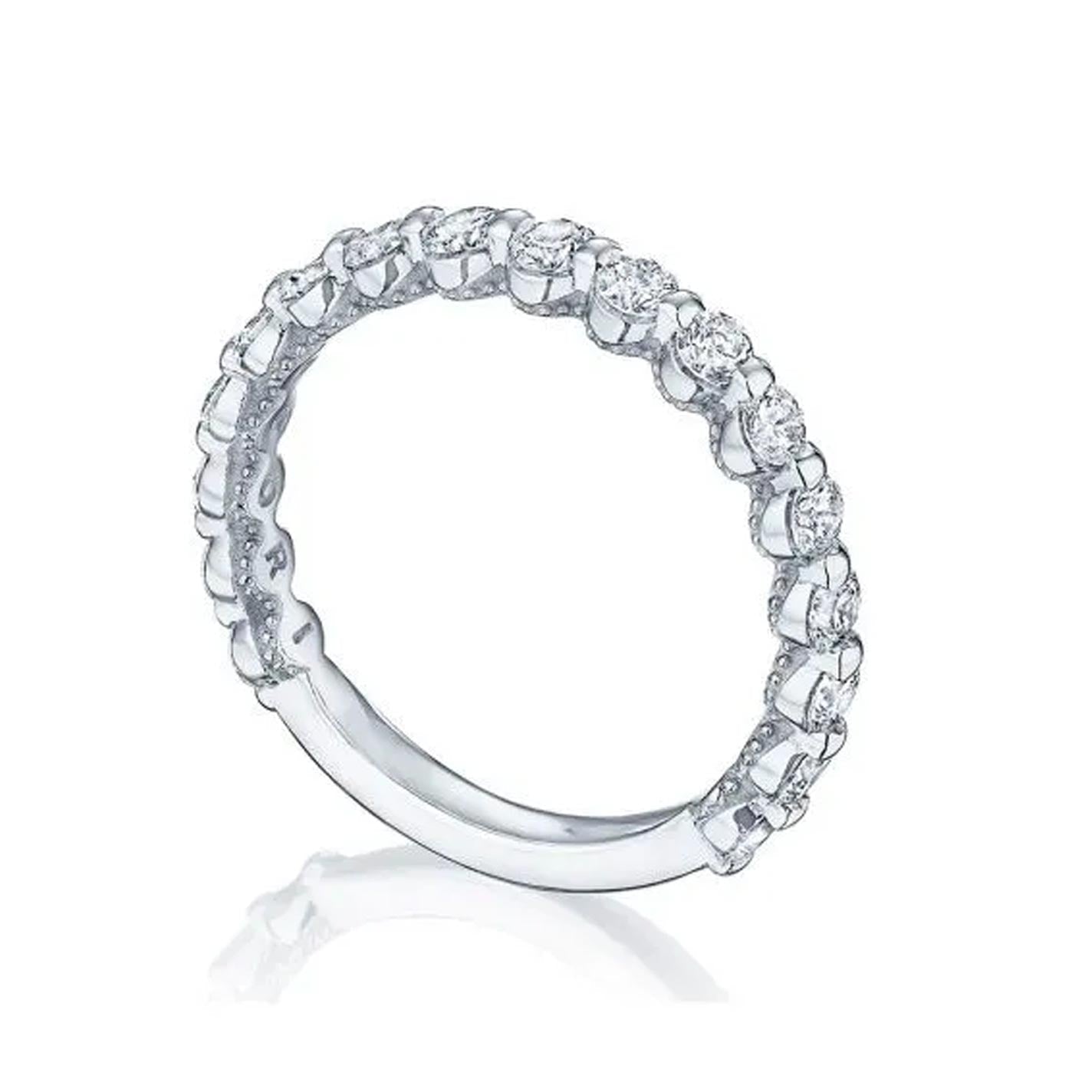 The Tacori Sculpted Crescent 18K White Gold Two-Prong Round Brilliant Diamond Anniversary Ring from the Tacori brand showcases a row of sparkling, round-cut diamonds encircling the band. Elegantly designed for engagement rings, it features a smooth inner surface and a two-prong setting for each diamond, beautifully displayed on a white background.