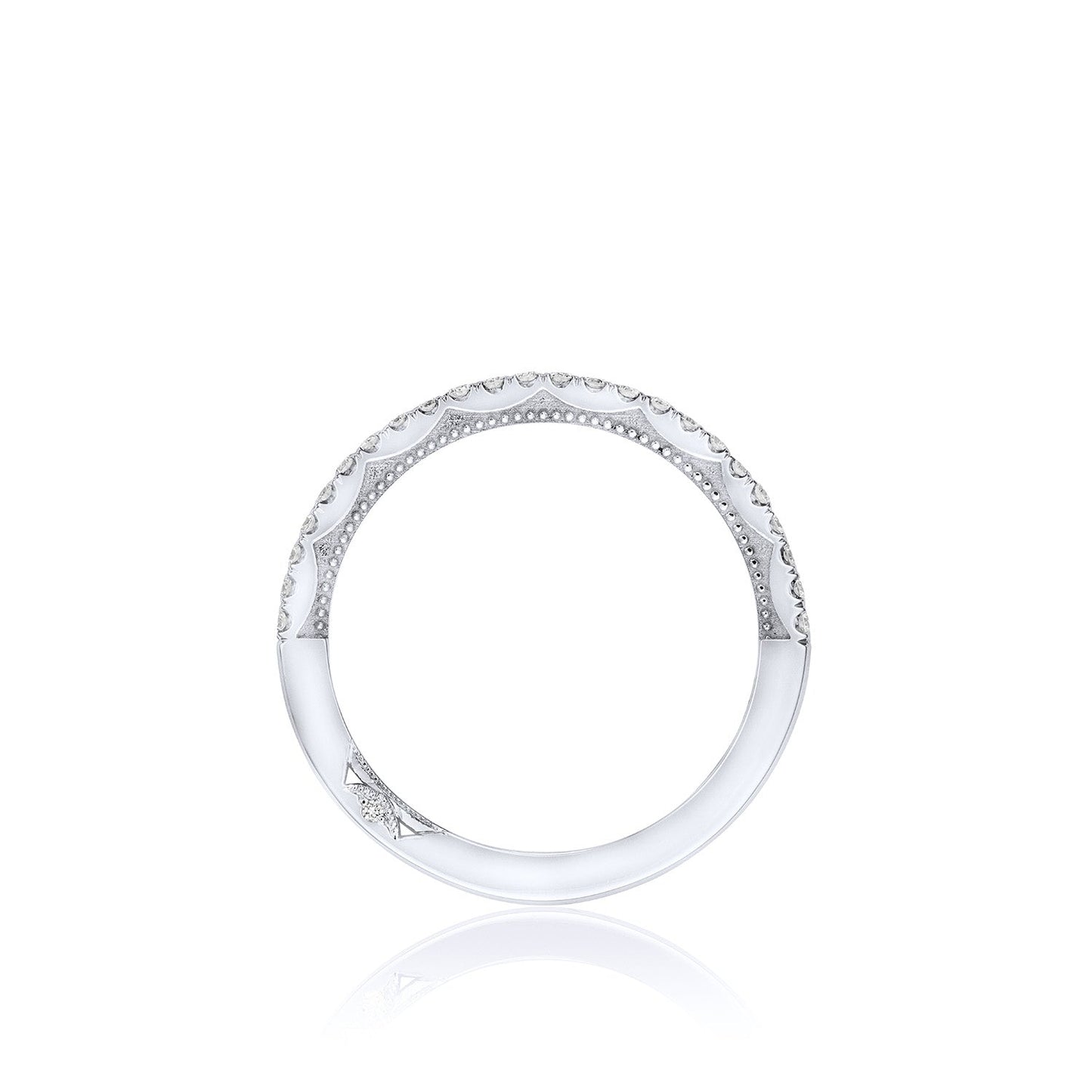 A refined, round anniversary ring adorned with intricate detailing in 18K white gold and a delicate pattern along the surface embodies the elegance of Tacori's iconic designs. The ring exudes minimalist sophistication set against a plain, white background.