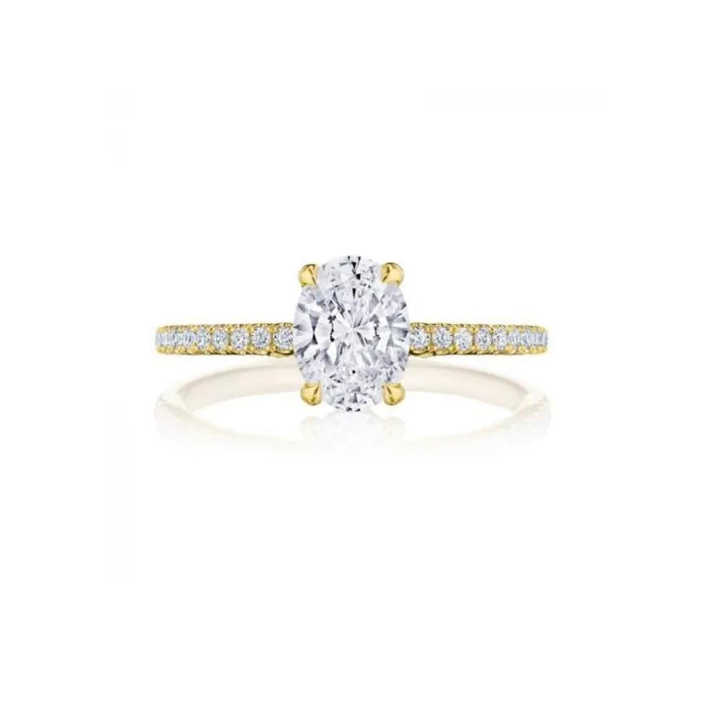 The Tacori Simply 18K Yellow Gold Oval Semi Mount Engagement Ring showcases a stunning oval diamond at its center, complemented by a French pavé band adorned with small round diamonds for a dazzling sparkle. Styled after Tacori's intricate crescent designs, this exquisite piece is elegantly displayed against a plain white background.