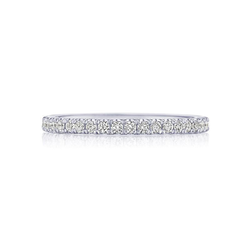 The Tacori Simply 18K White Gold Round Brilliant French Pavé Diamond Eternity Ring, showcasing a row of G color VS clarity diamonds set closely on a white gold band, is elegantly displayed against a white background, embodying the Signature Crescent style.