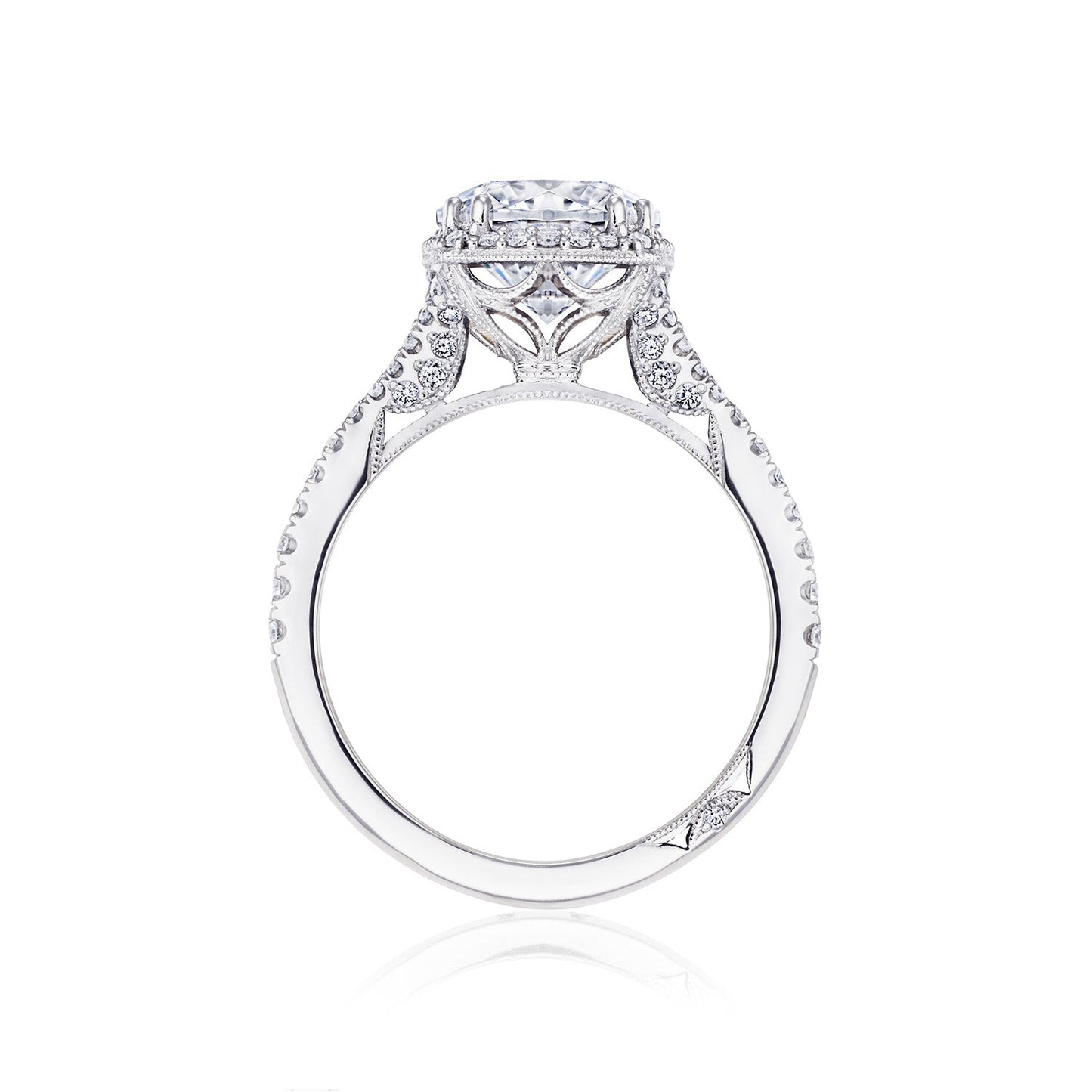 Side view of the Tacori Dantela 18K White Gold Cushion Semi Mount Engagement Ring, featuring a round central diamond set in a detailed, ornate white gold band with delicate engravings and smaller accent diamonds. The ring showcases fine craftsmanship, elegance, and the brilliance of G color diamonds through its intricate design with a diamond band and halo setting.