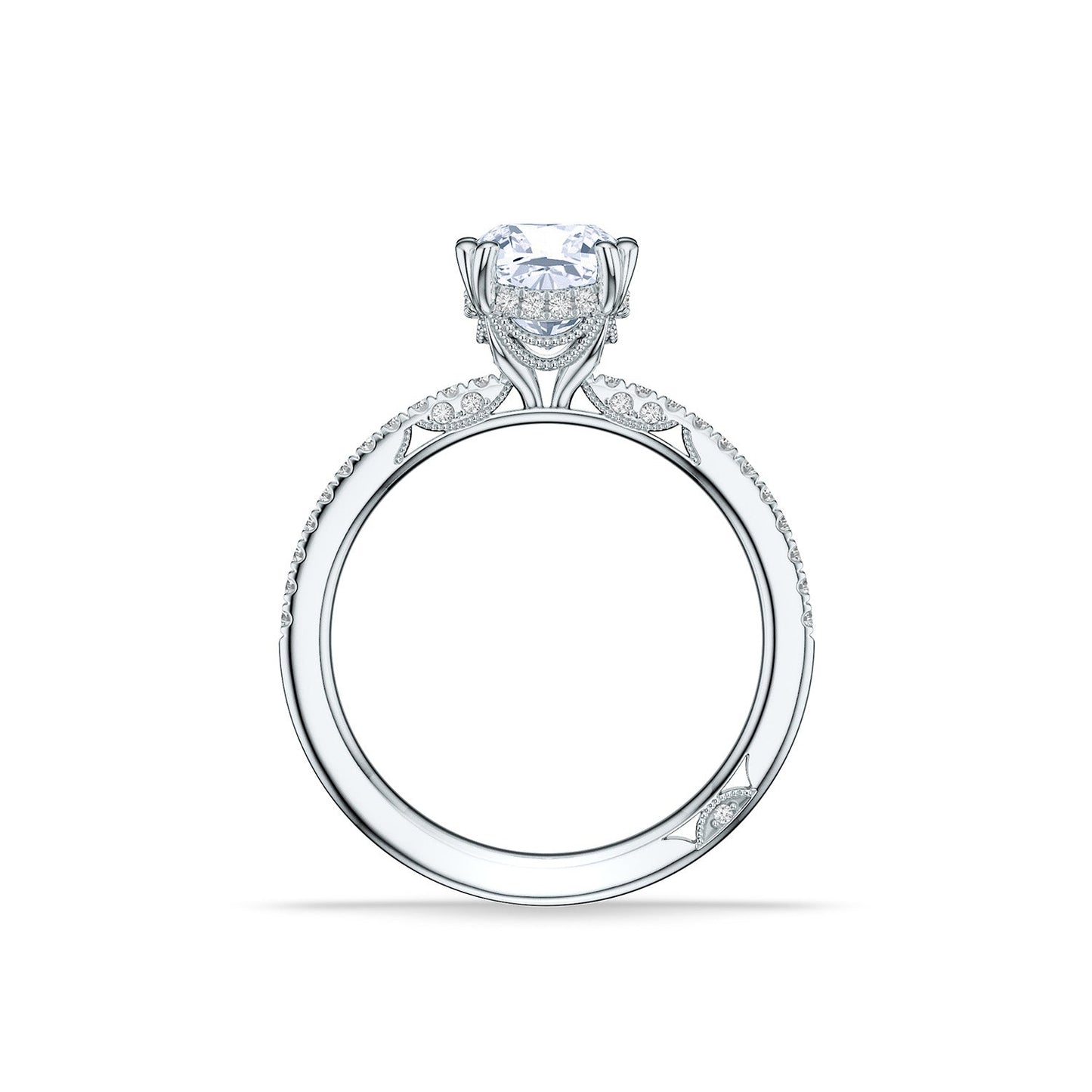 The Tacori Simply 18K White Gold Cushion Semi Mount with Diamond Band and Hidden Halo Engagement Ring offers an intricate view of elegance, featuring a stunning large diamond centerpiece and finely detailed pavé diamonds along the band. Set against a plain white background, this Tacori ring showcases unmatched craftsmanship and sparkling features, making it an ideal choice for those looking for exquisite bridal details.