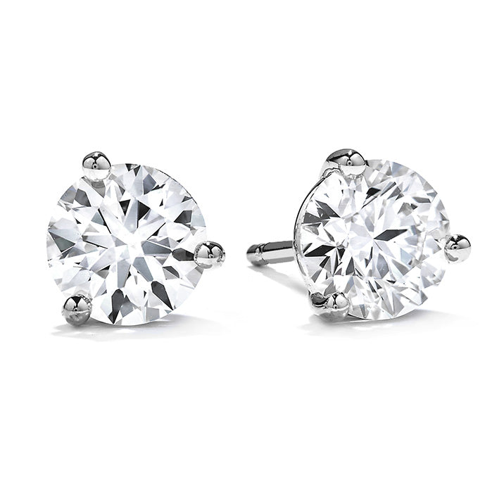 A pair of stunning Hearts On Fire Three-Prong Stud Earrings with silver prongs, set against a pristine white background.