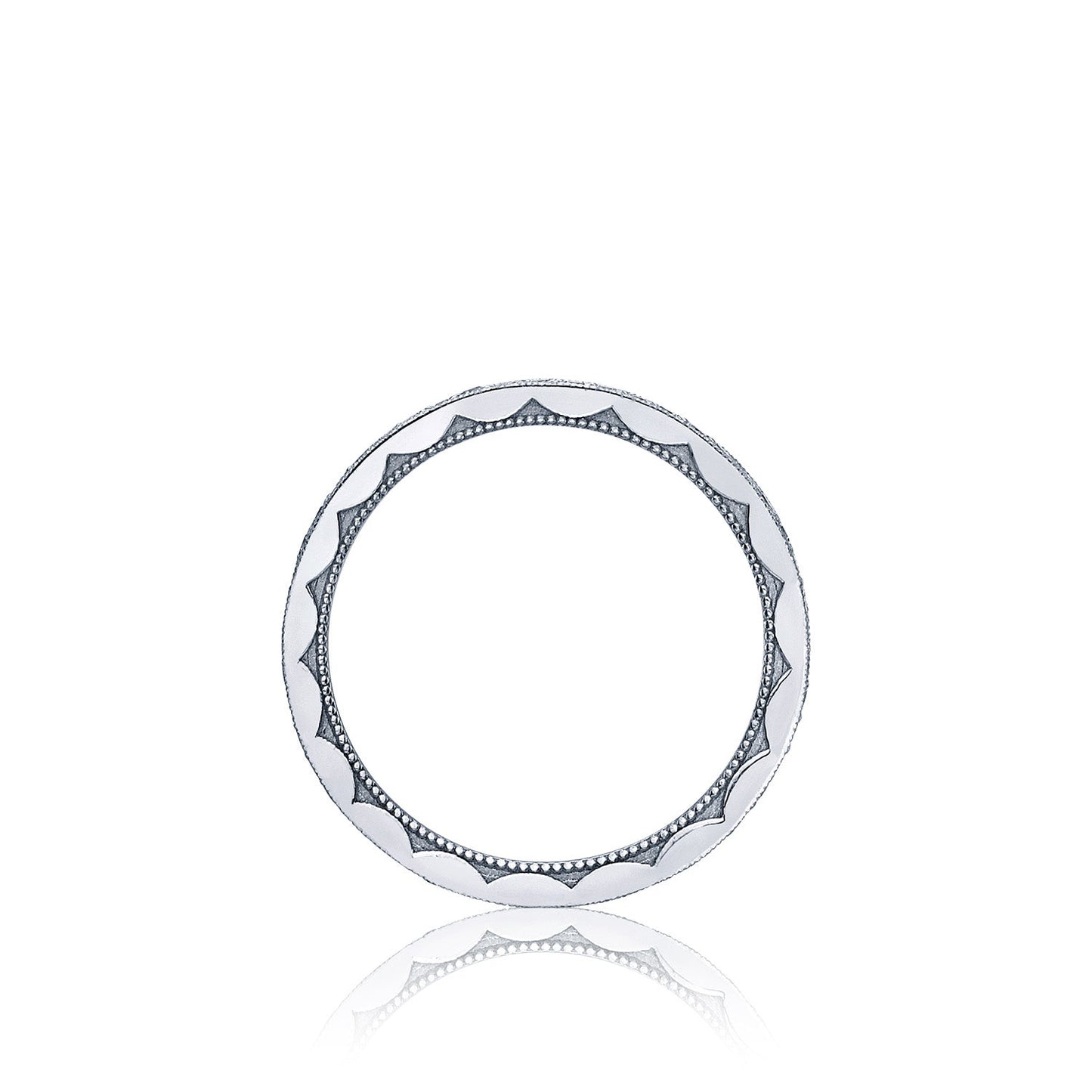 A circular platinum ring from Tacori, featuring an intricate scalloped and dotted design similar to a classic TACORI engagement ring, is set against a plain white background. This Tacori Sculpted Crescent Pavé Diamond Eternity Ring embodies a perfect blend of simplicity and elegance.