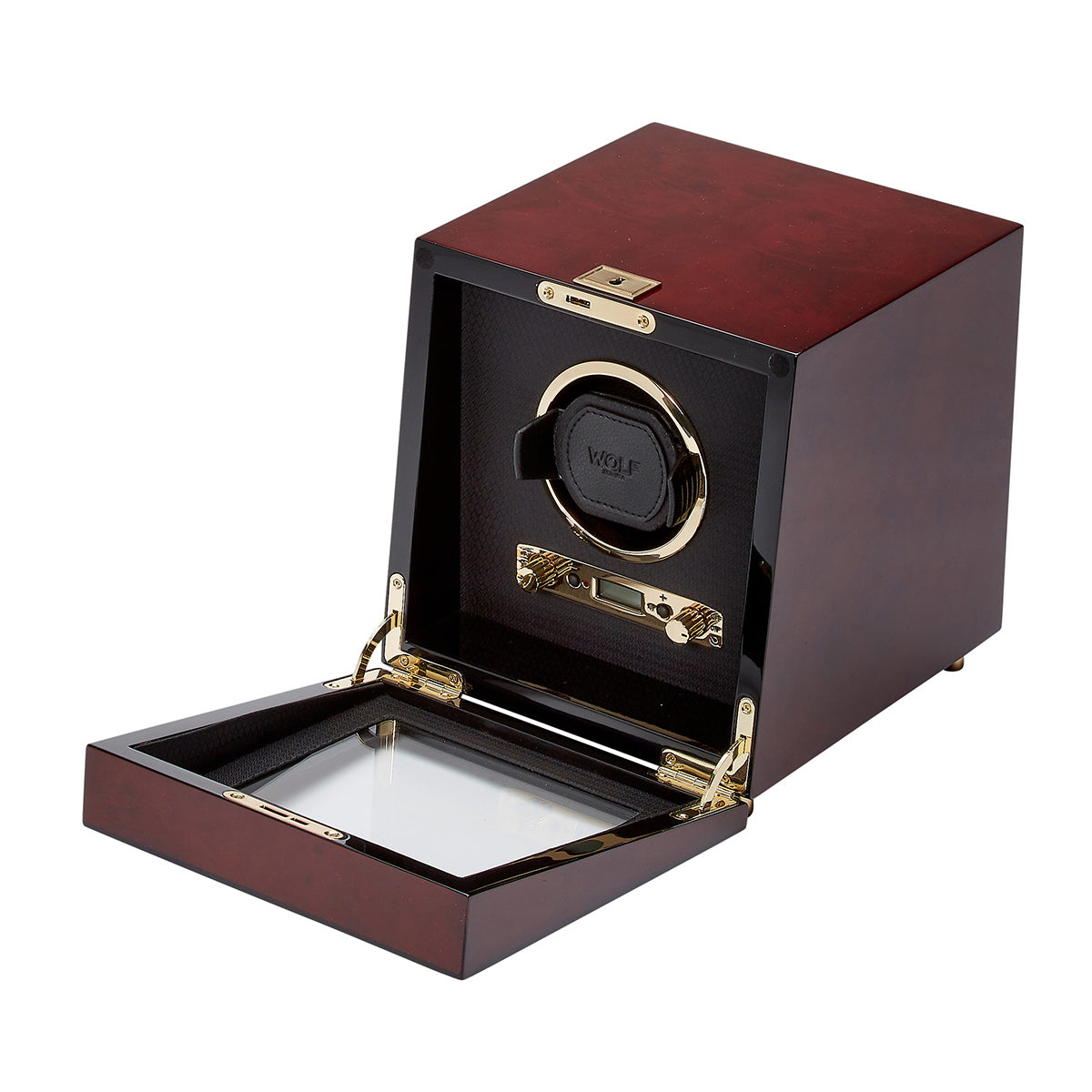Introducing the WOLF 1834 Savoy Single Winder, a refined creation from WOLF. This elegant watch winder is crafted from burl wood and showcases a glossy finish with gold-toned hinges and an open glass lid. Inside, the black compartment features a circular holder proudly bearing the "Wolf" logo. Designed with multiple rotation settings, it provides a secure sanctuary for keeping your automatic watches perfectly wound.