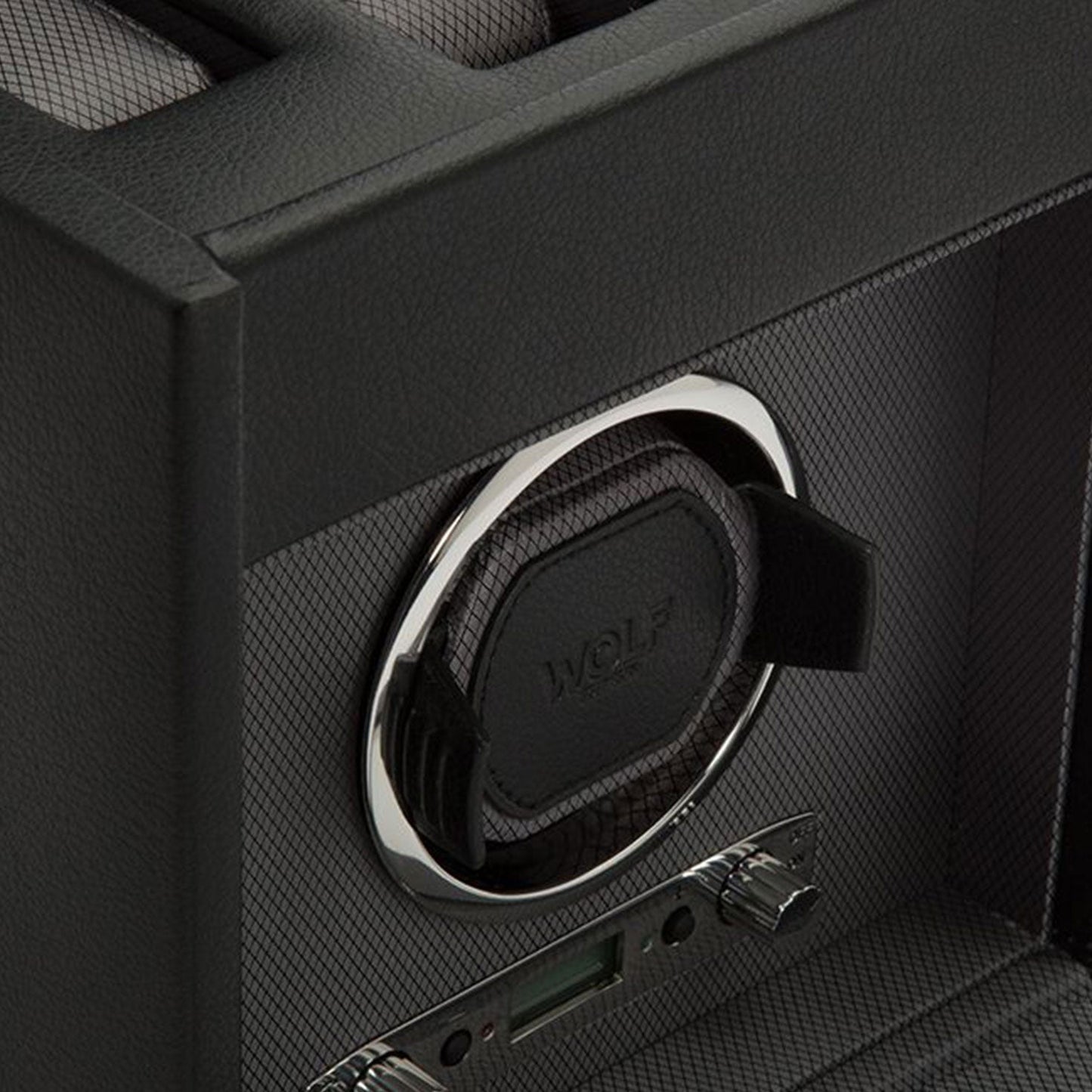 Close-up of a dark-colored WOLF 1834 Viceroy Single Winder with Storage, showcasing its circular holder and textured surfaces. This elegant accessory, from the renowned brand WOLF, features control knobs at the bottom to add a touch of sophistication to any collection.