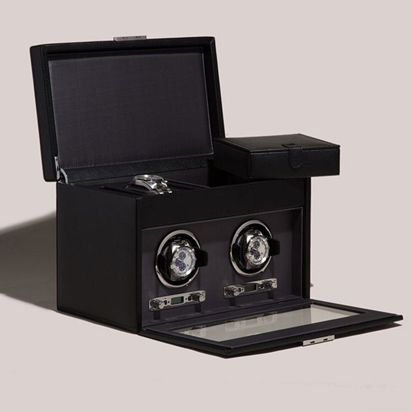 The WOLF 1834 Viceroy Black Watch Winder, from the renowned brand WOLF, showcases two silver rotating watch holders and an open lid. Positioned against a neutral backdrop, its glass front is slightly ajar to reveal the sleek interior details of this essential accessory, complete with a small compartment on top.