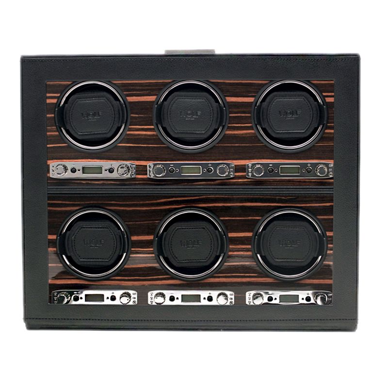 The WOLF 1834 Roadster 6 Piece Winder, crafted by WOLF, boasts six circular compartments with transparent covers arranged in two rows. Its interior features a wood-like finish, and control panels equipped with buttons and displays are positioned beneath each compartment. This watch winder offers a bi-directional setting for versatile use.